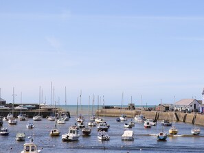 A marina with various boats docked along the shore. - Blaenywawr (Lampeter)