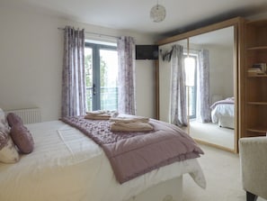 Enjoy a restful stay in this stylish room featuring a large bed, wardrobe, and balcony.