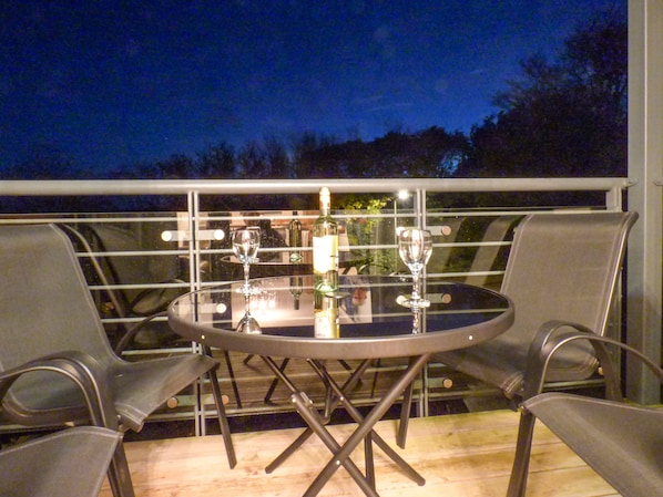 Enjoy a romantic dinner for two at this intimate outdoor dining area, complete with a round table and comfortable seating.