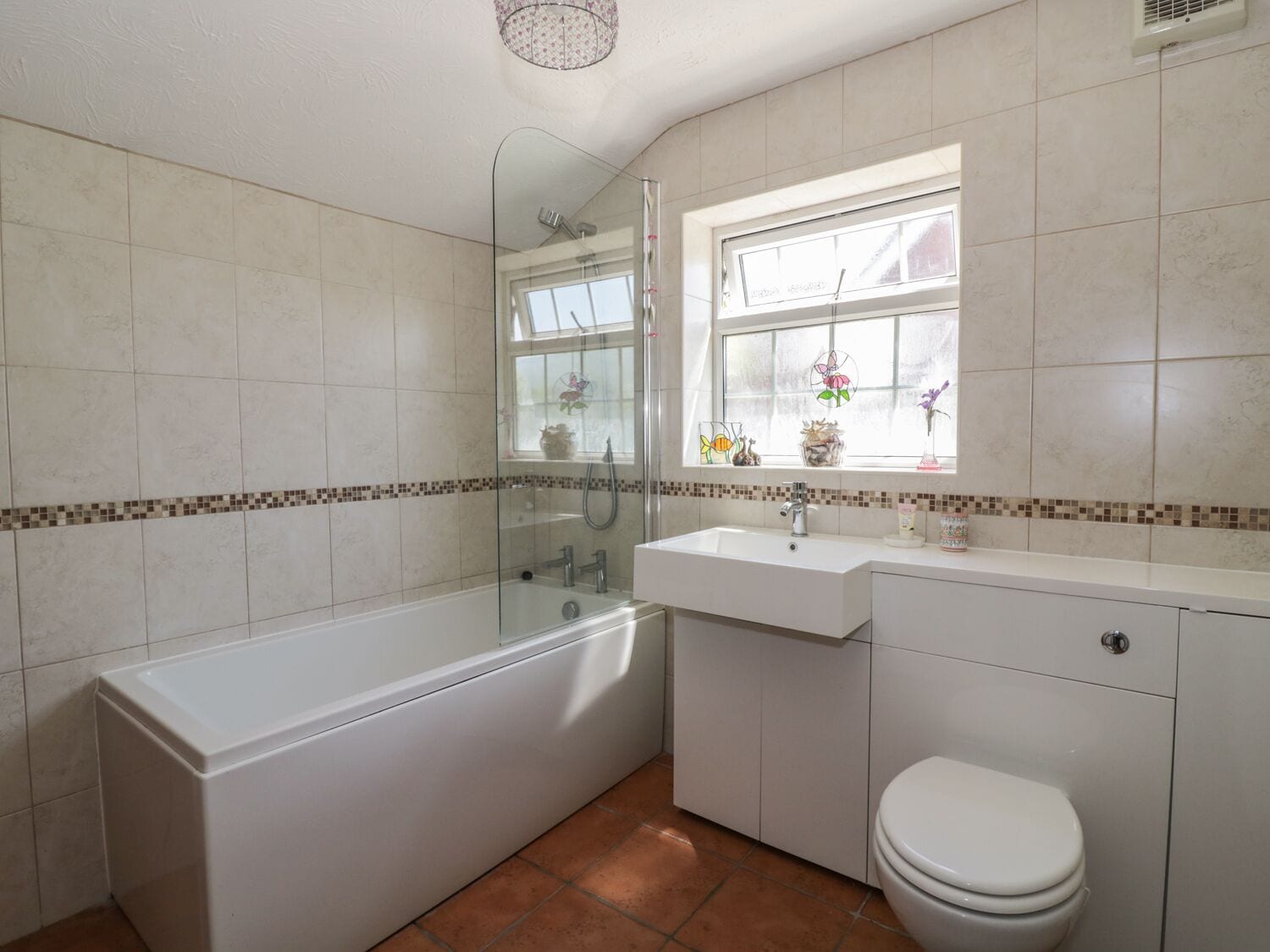 Een badkamer met een bad, wastafel en toilet.