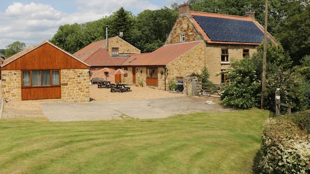 A stone building with a red-tiled roof and solar panels. - Little Byre Cottage (Thirsk)