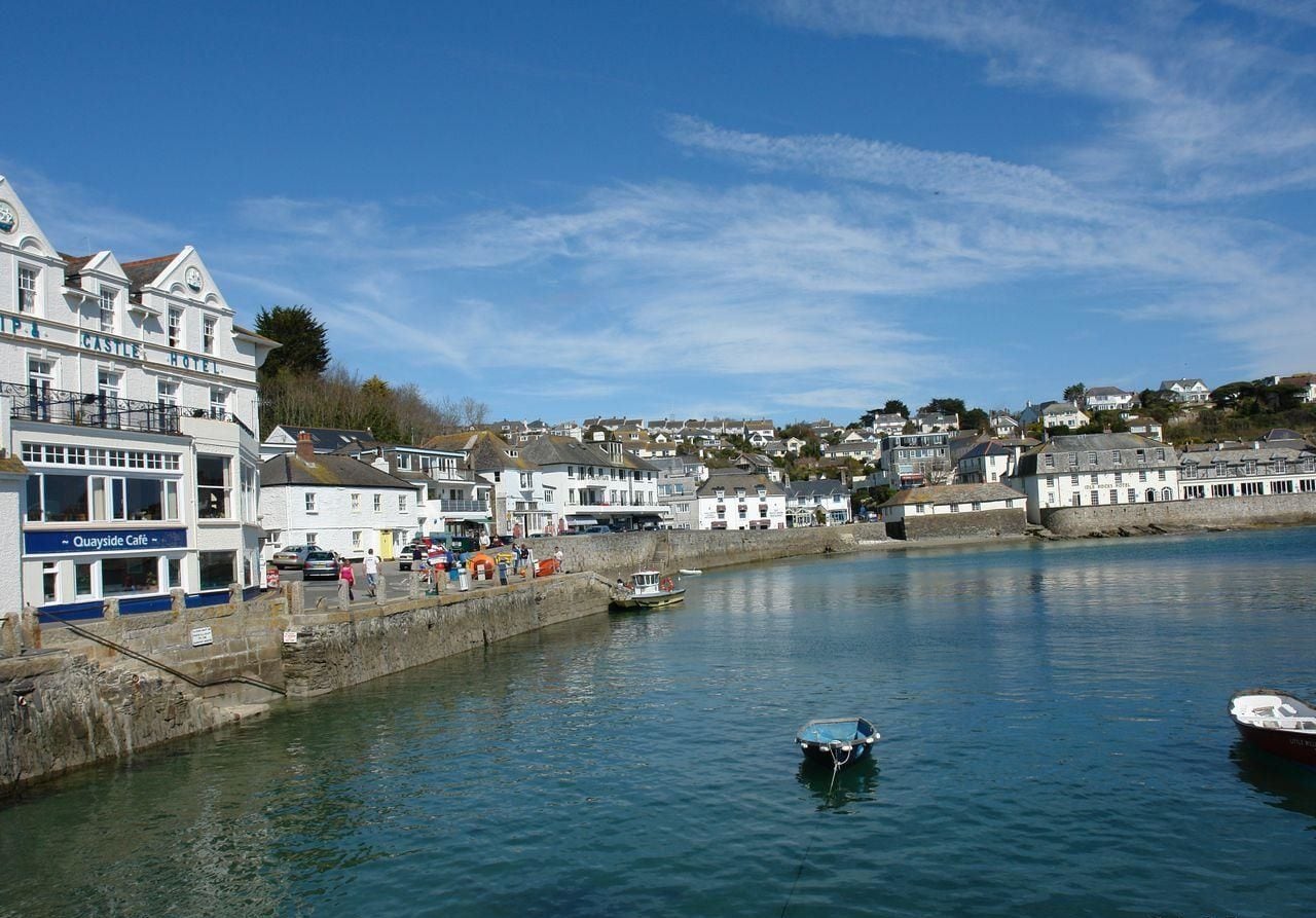 A coastal town with a prominent white building labeled "CASTLE HOTEL" and a "Quayside Café" on the left.