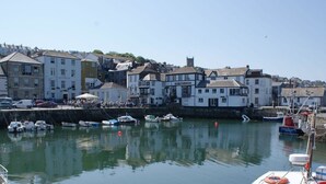 A harbor with boats docked, buildings along the waterfront, and a clear sky. - 1 Florence Place (Falmouth)
