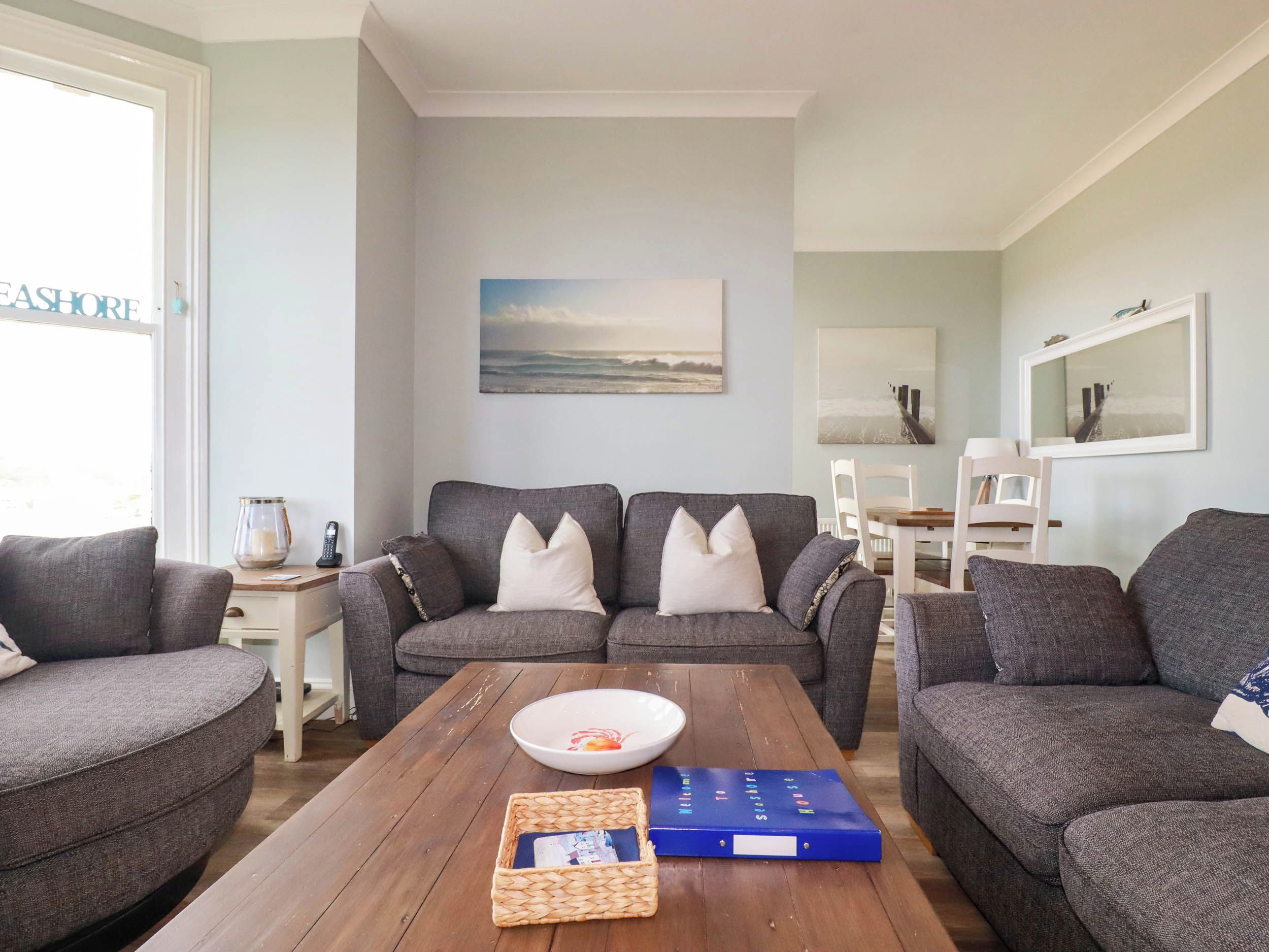 A living room with a sofa set, a coffee table, and a bookshelf.