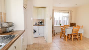 Cottage | Privékeuken | Een microgolfoven, een kookplaat, een vaatwasser, een kinderstoel