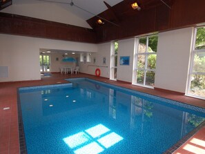 Relax by the pool surrounded by a red-tiled floor and natural light pouring in through the windows.