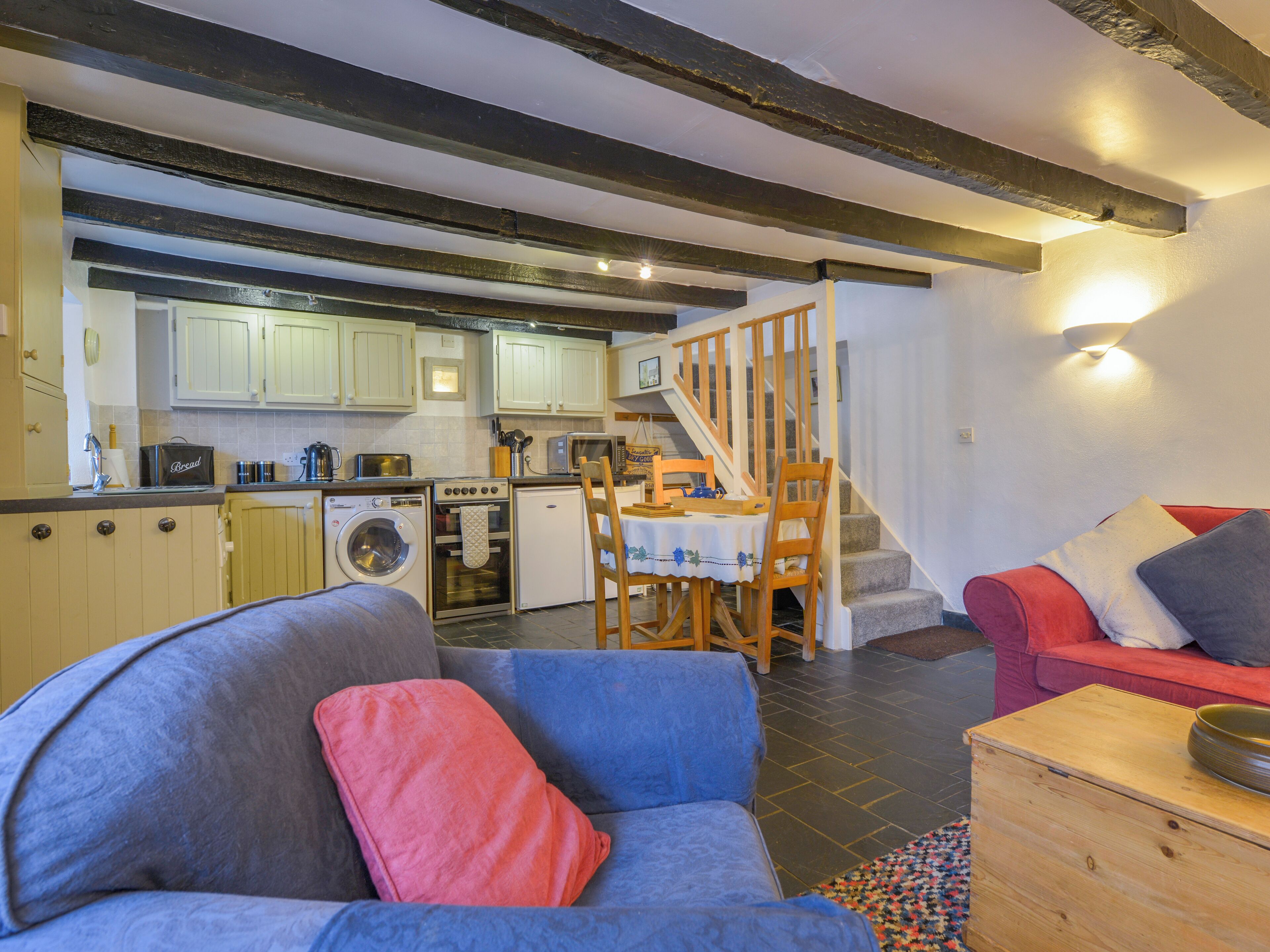 A compact living space with a kitchen, dining area, and seating area.