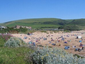 A beach with numerous tents and people. - Fairways (Woolacombe)