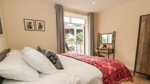 A bedroom with a bed, a desk, and a chair. - Rhianwen, Plas Moelfre Hall Barns (Oswestry)