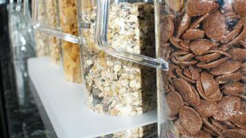 A row of clear containers with various food items on a countertop.