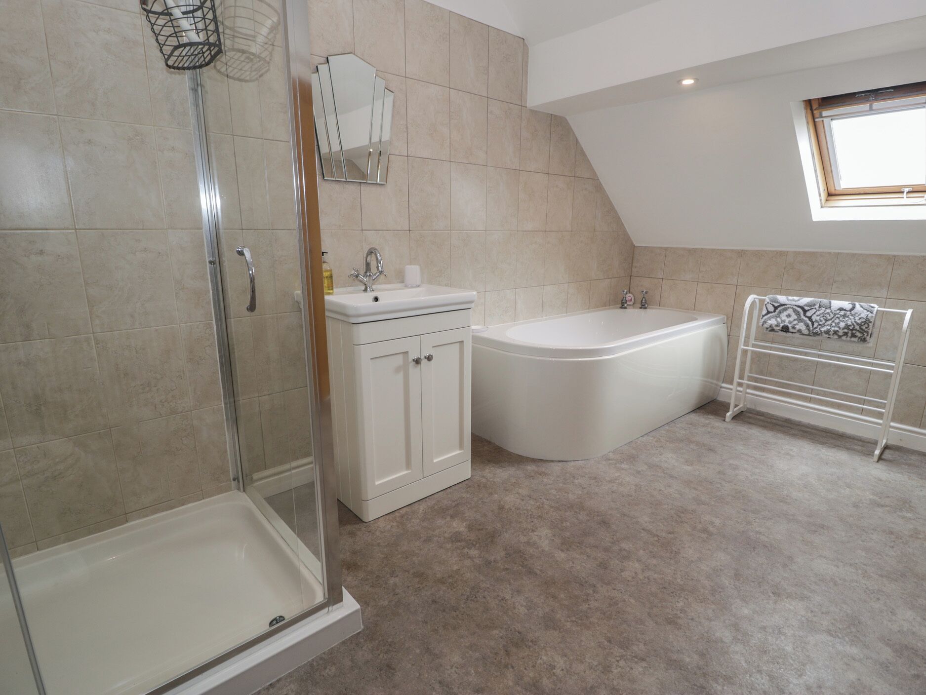 A modern bathroom with a shower, sink, and bathtub.