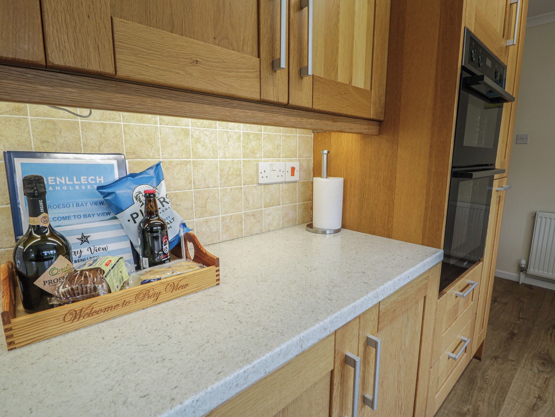A kitchen with wooden cabinets, a countertop, and a tiled backsplash.