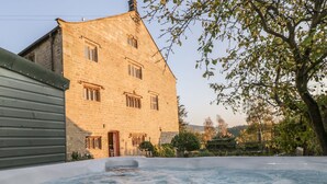 A stone building with a hot tub in front. - High Hall (Skipton)