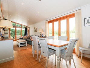 Relax in this inviting space with a dining area, sofa, and large windows.