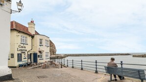 A coastal pub named 'Cod & Lobster' with outdoor seating and a view of the sea. - Bramla (Saltburn-by-the-Sea)