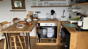 A compact kitchen with wooden countertops, a built-in oven, and a sink. - Shepherds Cabin at Titterstone Hot Tub &amp; Dog-friendly Near Ludlow (Ludlow)