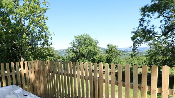 A wooden fence with a clear view of a landscape in the background. - Ty Ffarm at Gellilwch (Pontypridd)