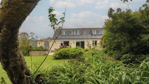 A two-story house with a garden in front.