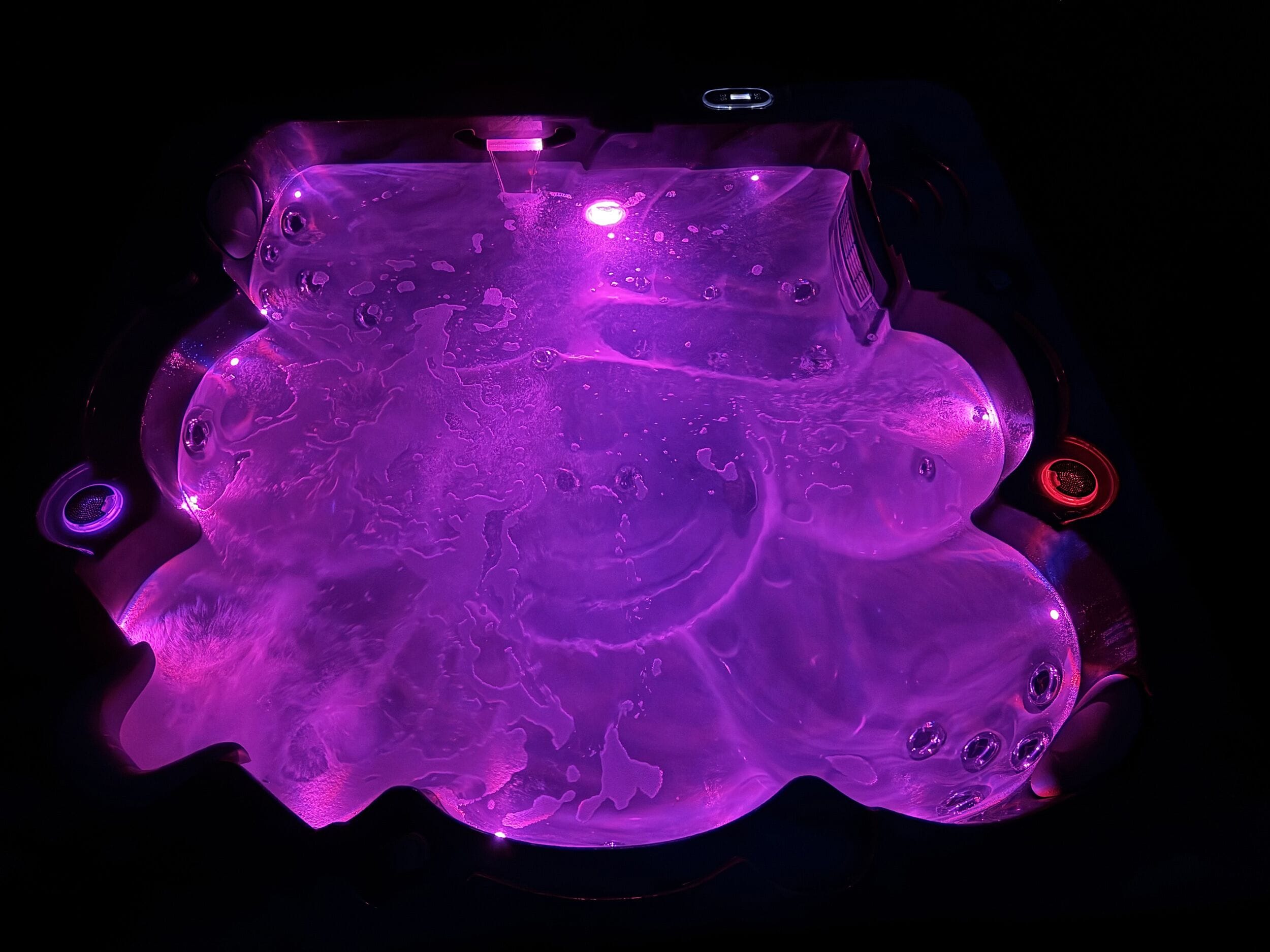 A hot tub with a purple light.