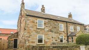 A stone building with multiple windows and a door, likely a farmhouse or cottage. - Street House Farm Cottage (Saltburn-by-the-Sea)