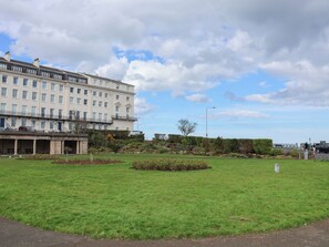 A large building with multiple windows and a flat roof, surrounded by a well-maintained grassy area and some shrubs. - Archie's Anchor (Scarborough)