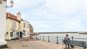 A coastal pub named 'Cod & Lobster' with outdoor seating and a view of the sea. - Clevelyn (Saltburn-by-the-Sea)