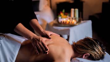 Experience a serene massage therapy session in a peaceful room designed for ultimate relaxation.