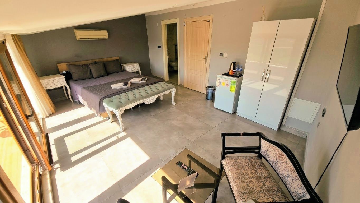 A bedroom with a bed, bedside table, and a wardrobe.