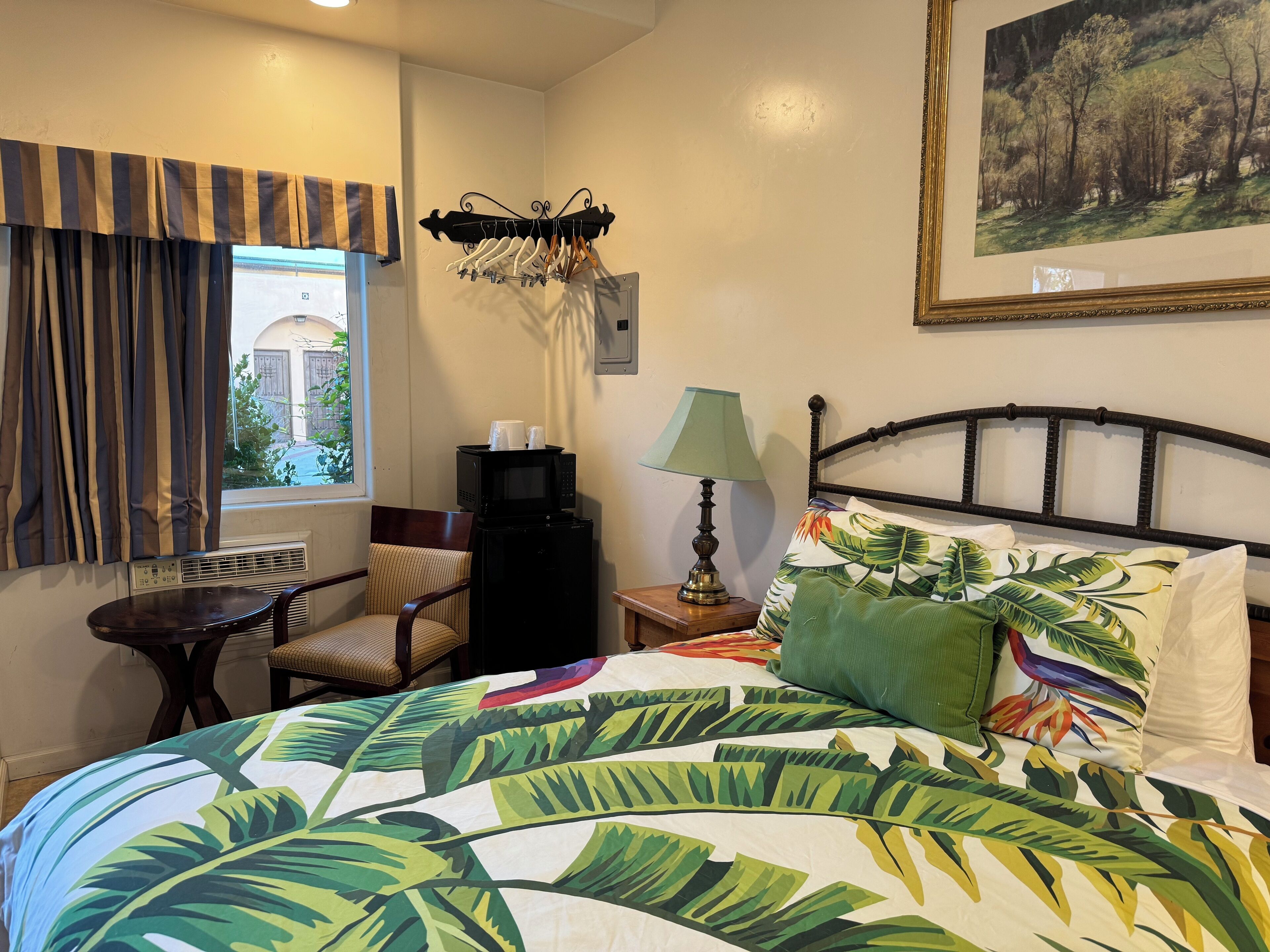 Desk, laptop workspace, blackout drapes, iron/ironing board