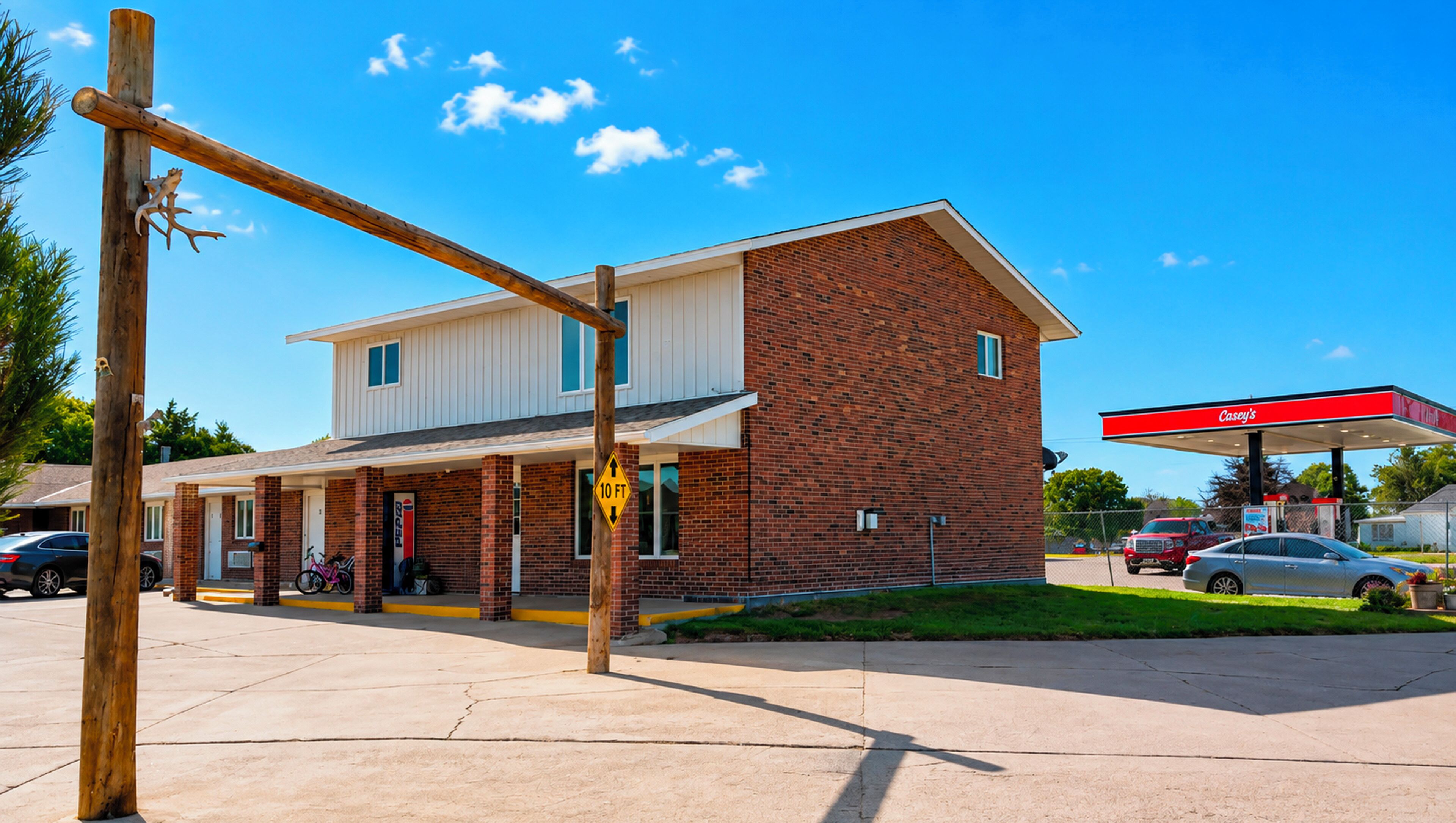 A two-story building with a brick facade, a flat roof, and a visible garage door.
