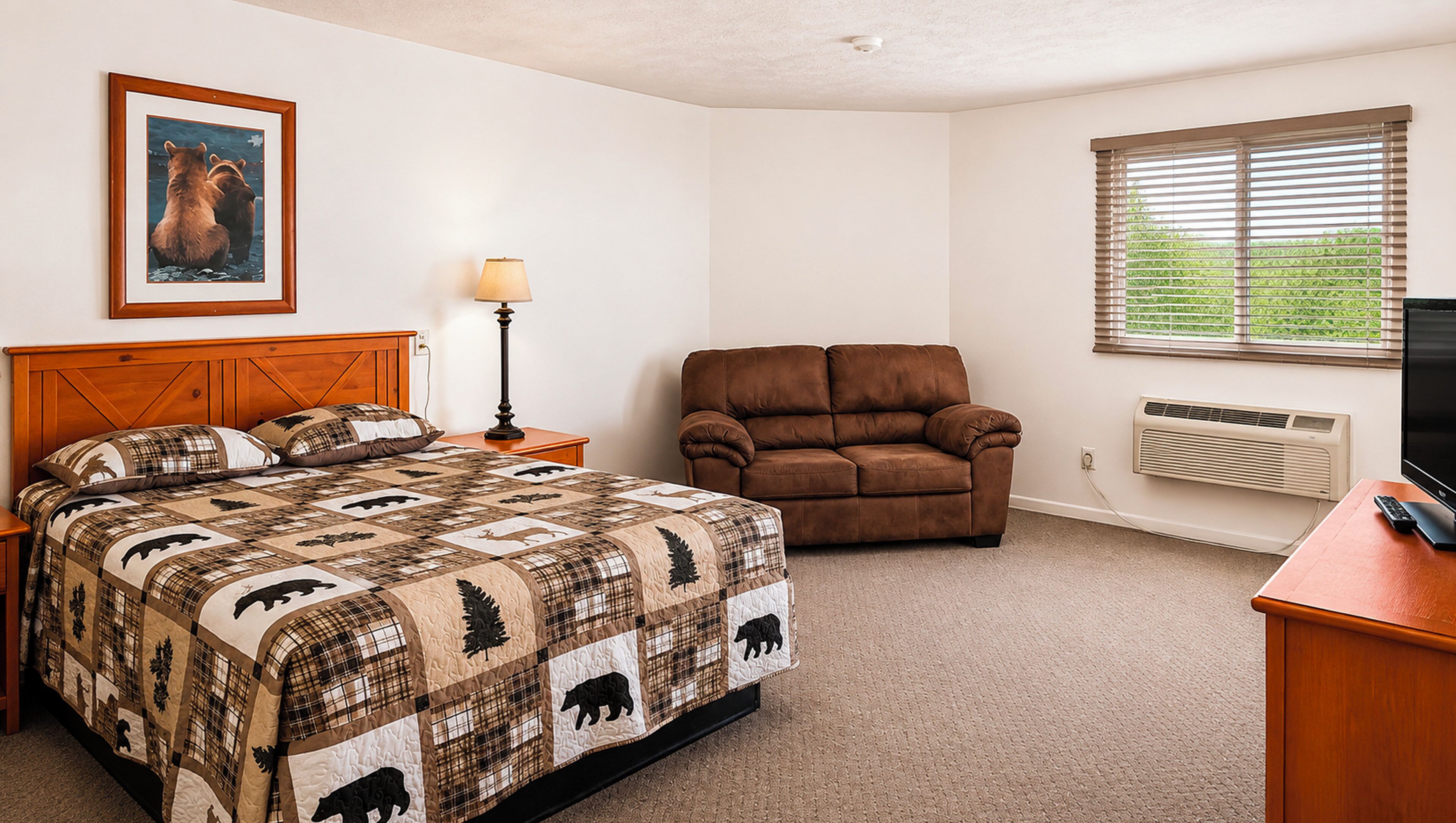 A bedroom with a bed, a brown leather chair, a bedside table with a lamp, a wall-mounted TV, and a window with blinds.