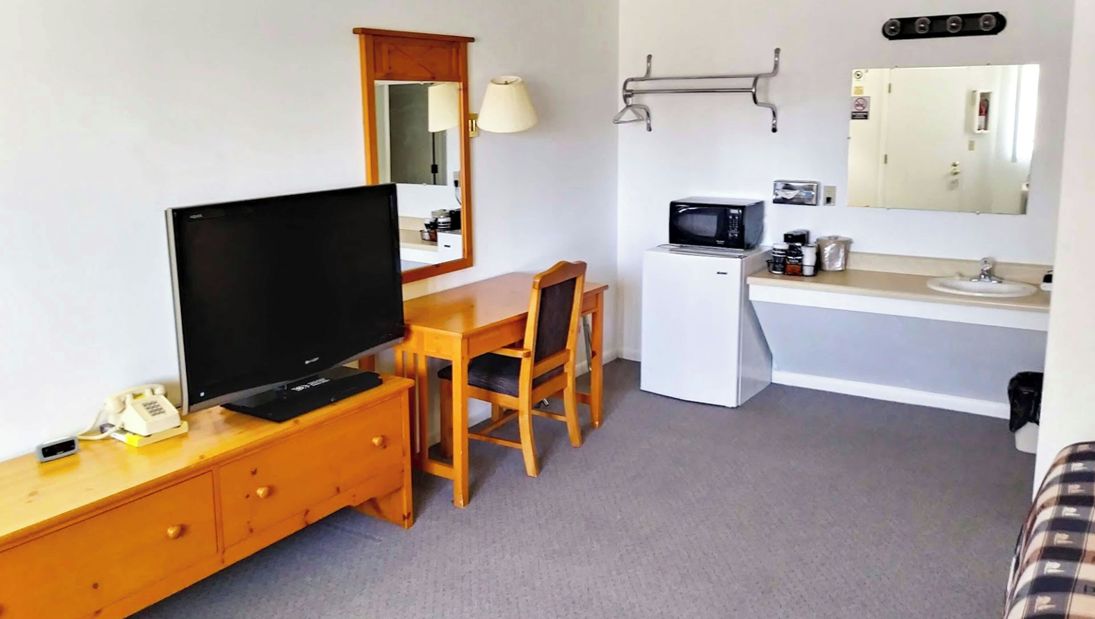 Desk, laptop workspace, blackout drapes, iron/ironing board