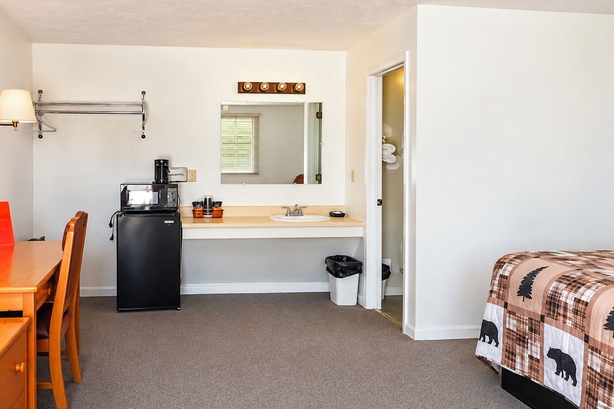 Desk, laptop workspace, blackout drapes, iron/ironing board