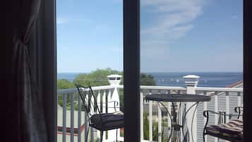 Enjoy breathtaking ocean views from this balcony with a table and chair.