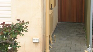 A beige building with a wooden gate and a wall sign that says "Seas the Day." - Spoil yourself! Gateway- McLaren Vale wineries, Moana Beach & Onkaparinga Gorge! (Moana)