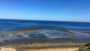 A coastal landscape with clear blue water and a rocky shoreline. - Spoil yourself! Gateway- McLaren Vale wineries, Moana Beach & Onkaparinga Gorge! (Moana)