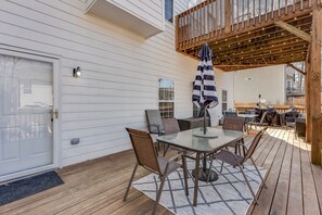 A covered patio with a table and chairs, a wooden deck, and a view of a neighboring house. - Atlanta Luxury Home (8bedrooms)  (Atlanta)