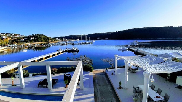 A marina with boats, a pool, and outdoor seating. - Apartments Raffaello - Bedroom S2 (Kampor)