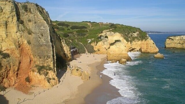 A coastal landscape with a sandy beach, rocky cliffs, and a clear sky. - You will love a holiday in this beautiful, spacious apartment. Licence 161917/AL (Lagos)