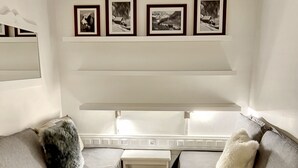 A modern living room with two grey sofas, a small white side table, and a wooden floor. - Standing Apartment 4 people + Parking + Ski locker - Arcs 1800 (Bourg-Saint-Maurice)