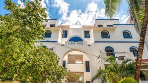A building with a sign reading "Luna Azul" and a staircase leading to the entrance. - Ground-Floor Beachfront Living with Private Patio (Akumal)