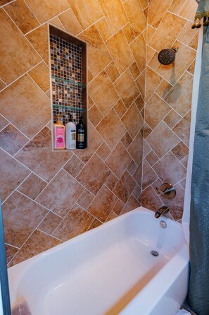 Bathtub, hair dryer, towels, shampoo