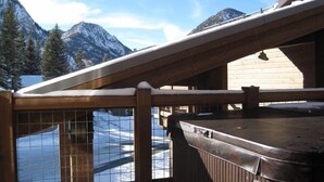 A wooden balcony with a view of snow-covered mountains and a clear sky. - Luxury Condo, Private Hot Tub, Perfectly Located (Frisco)