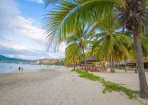 On the beach, sun-loungers