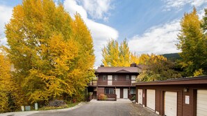 A two-story building with a front parking area, a covered driveway, and a row of garage doors. - Outpost: Pitchfork 446 - Close to Snow King Mtn! (Jackson)