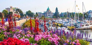 Stunning waterfront landmark with a prominent dome and lush gardens, surrounded by a bustling marina and vibrant public space.
