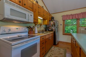 Enjoy cooking in this well-equipped kitchen with an oven, sink, and refrigerator.