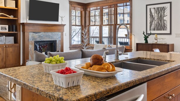 A modern kitchen with granite countertops, stainless steel appliances, wooden cabinets, and pendant lighting. - Outpost: Love Ridge 241 - Freestanding, AC! (Jackson)