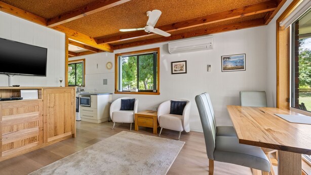 A modern cabin interior with a kitchen, dining area, and seating space. - Kalamunda 6 - On the Rail Trail (BRIGHT)