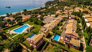 A coastal resort with multiple villas, a central swimming pool, and a beach. - Akti Barbati Houses by Konnect (Corfu)